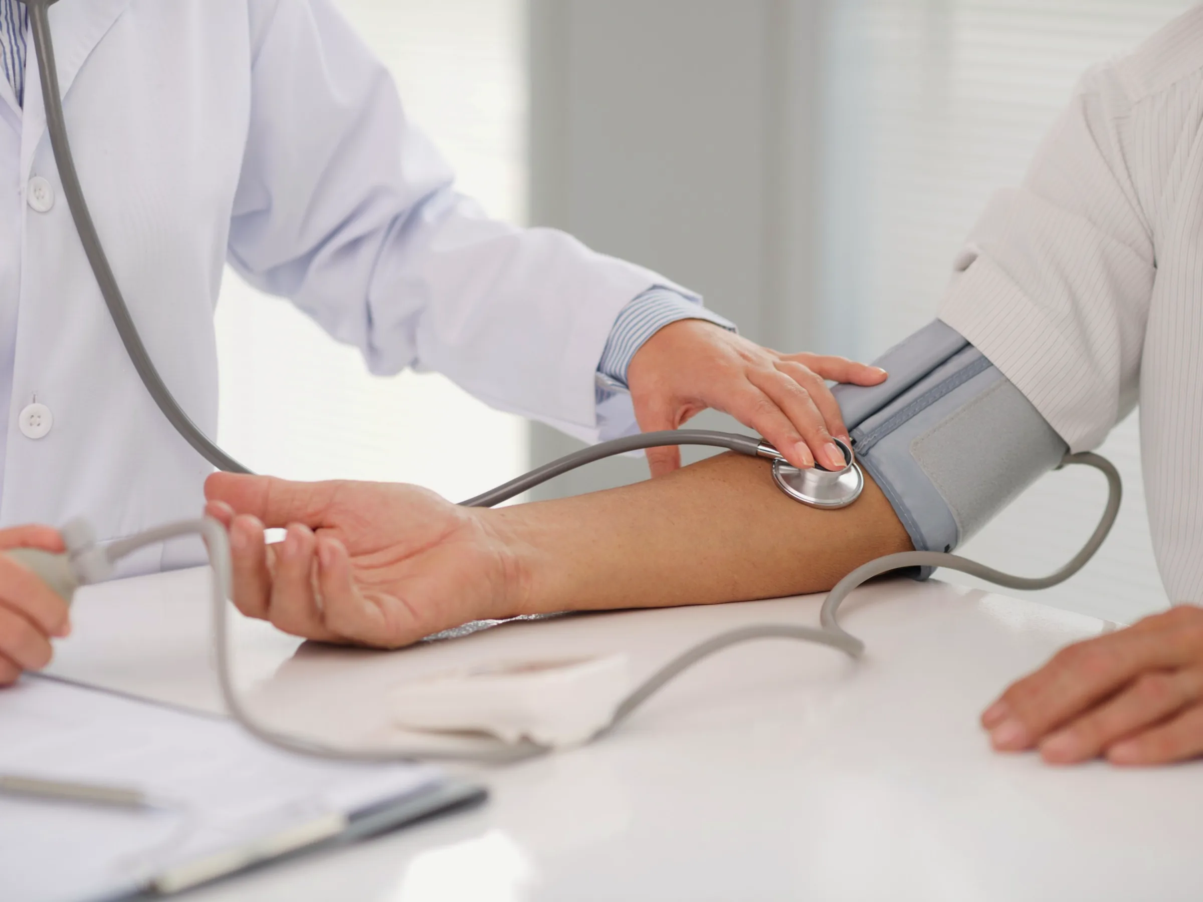 A physician checking a patient's blood pressure