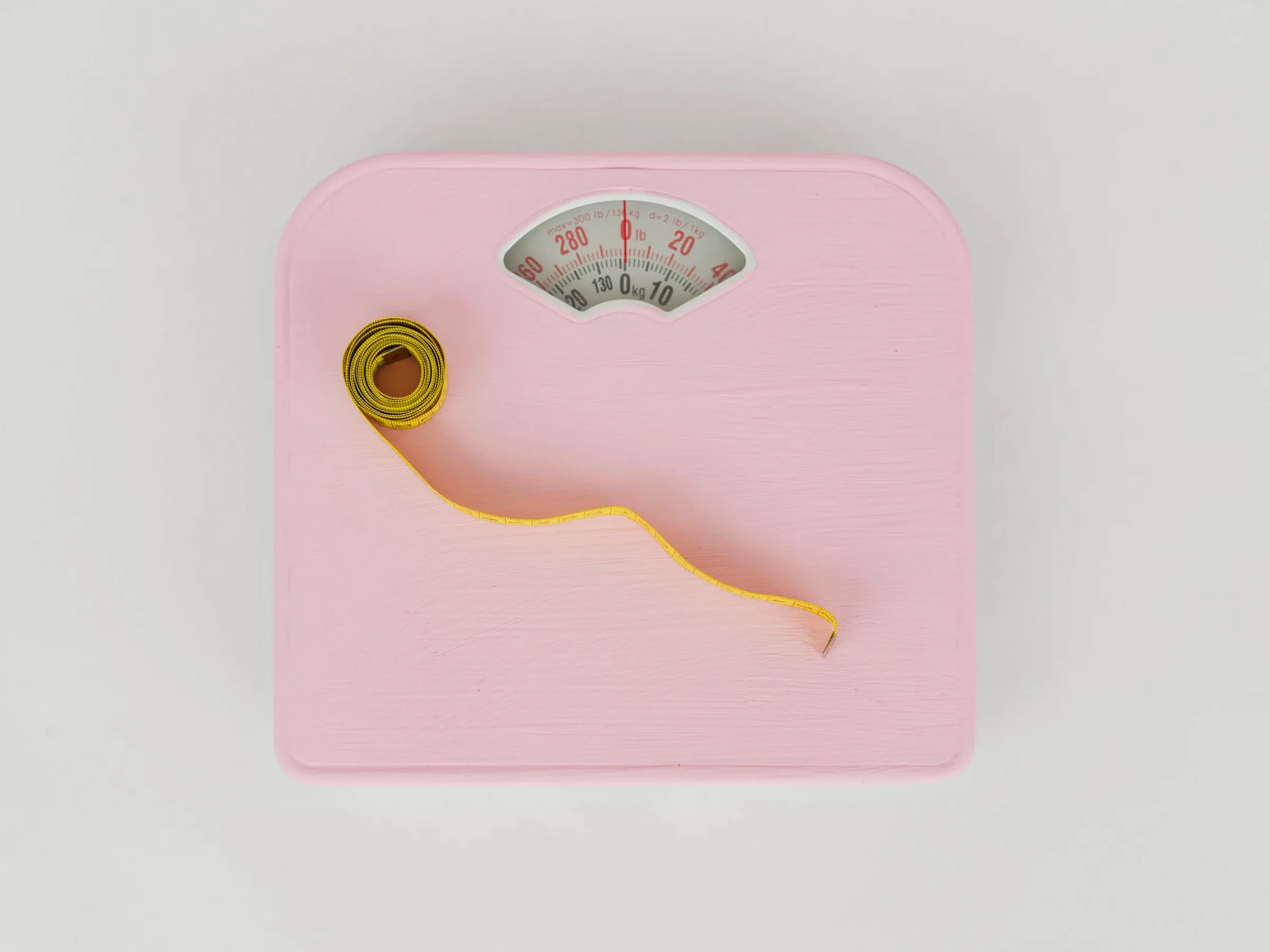A bathroom scale and a tape measure